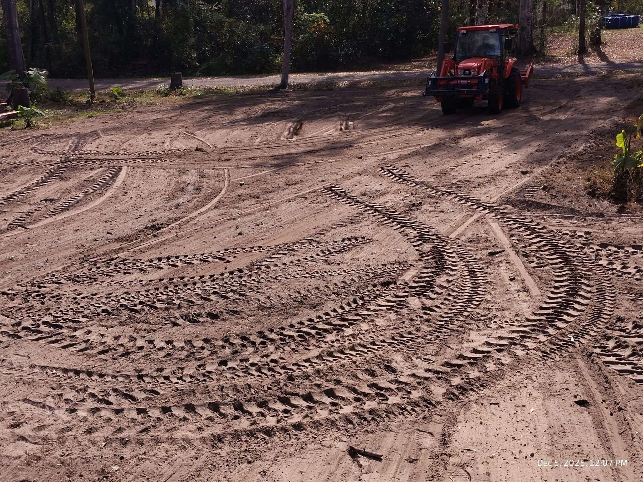 Tractor grading land