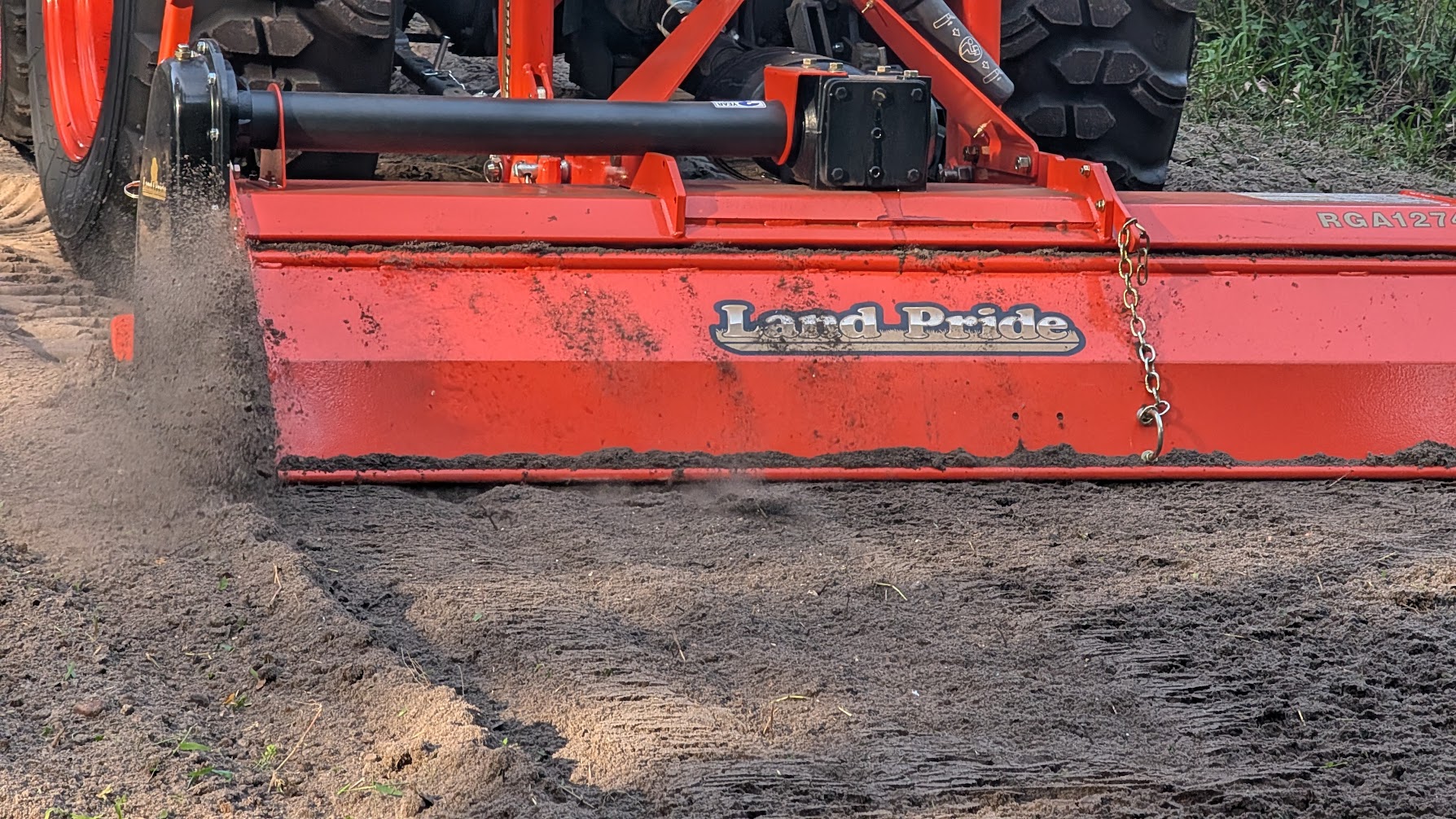 Tractor with rototiller preparing soil